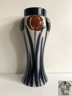 a black and white vase sitting on top of a table