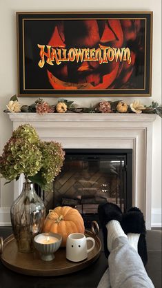 the fireplace is decorated for halloween with pumpkins, candles and other decorations on it