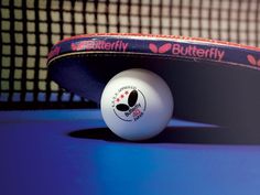 a ping pong ball sitting on top of a net