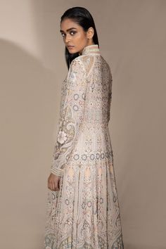 Opal jacket with floral embroidered motifs and cutdana embellishment. Comes with blouse and trousers.
Components:3
Pattern:Embroidery
Type of Work:Cutdana and Thread
Neckline:Band
Sleeve Length:Full
Fabric:Chiffon
Color:White
Other Details:
Closure: Hook front
Note: Belt worn by the model is not for sale
Occasion:Wedding - Aza Fashions Spring Bandhgala With Intricate Embroidery And Long Sleeves, Designer Long Sleeve Outerwear With Floral Embroidery, Designer Floral Embroidered Long Sleeve Outerwear, Fitted Long Sleeve Bandhgala With Floral Embroidery, Silk Outerwear With Chikankari Embroidery, Bollywood Style Embellished Long Sleeve Bandhgala, Embellished Bollywood Bandhgala With Long Sleeves, Embellished Bollywood Bandhgala, Wedding Bandhgala With Floral Embroidery And Long Sleeves