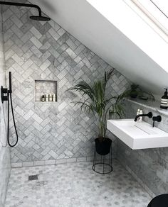 a bathroom with a white sink and tiled walls