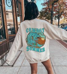 The Beach Cowboy Surf Skeleton Sweatshirt is a retro western-inspired oversized shirt that features a Coastal Cowgirl print. This preppy and stylish beach tee is perfect for VSCO and Coconut Girl teens who love Y2K fashion:)   *USUALLY SHIPS WITHIN 1-4 DAYS* -Gildan crewneck sweatshirt -For oversized look size up 1-2 sizes -Comfy & Cozy -Ink designs -Collar is ribbed knit, so it retains its shape even after washing. -No itchy side seams -50% cotton, 50% polyester -Medium-heavy fabric -Loose fit -Sewn-in label -Runs true to size -Machine Wash Cold ---WE DO NOT EXCEPT RETURNS OR CANCELLATIONS--- Beach Cowboy, Cowgirl Print, Skeleton Sweatshirt, Beach Tee, Retro Western, Y2k Summer, Coconut Girl, Coastal Cowgirl, Comfy Cozy