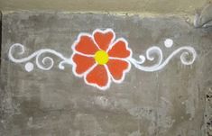 a painted flower on the side of a cement wall