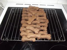 there is a dog bone on top of the oven rack in the oven, ready to be cooked