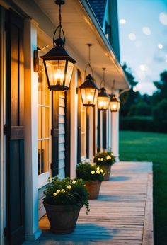 some lights that are on the side of a house and in front of a porch