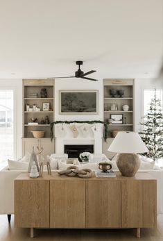 a living room filled with furniture and a christmas tree in the middle of the room