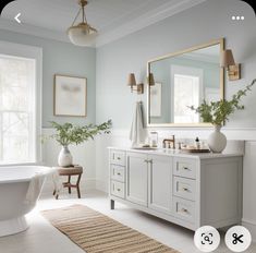 a bathroom with a tub, sink, mirror and rug on the floor in front of it