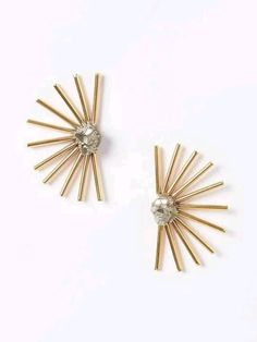 two pairs of gold tone earrings with crystal stones on each side and sunbursts in the middle