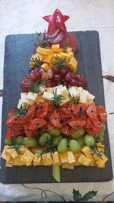 a christmas tree made out of cheese and grapes