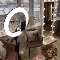 a living room filled with furniture and a large mirror on the wall next to a window