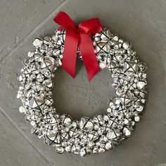 a christmas wreath with bells and a red bow