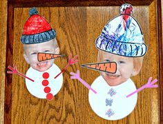 two children's hats made out of paper on top of a wooden frame with one child wearing a snowman hat