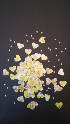 some yellow and white hearts on a black background