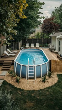 an above ground swimming pool with steps leading up to it and a deck in the background