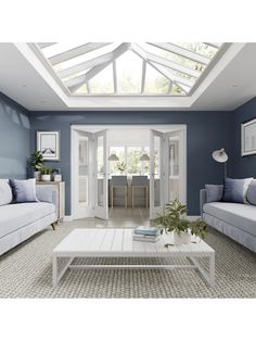 a living room filled with furniture and a skylight above the couches in front of it