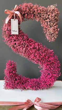 the number two is made out of pink flowers