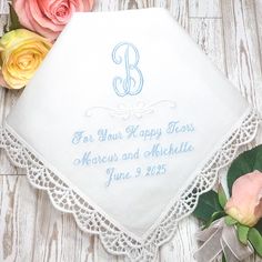 a personalized wedding handkerchief on a table with flowers