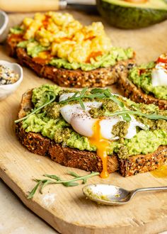 toast with avocado and poached egg on it sitting on a cutting board