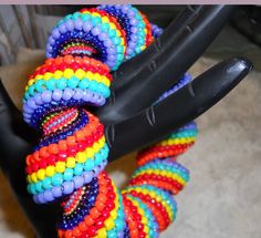 a bunch of bracelets that are sitting on a stand