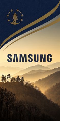 the samsung logo on top of a mountain with trees in the foreground and mountains in the background