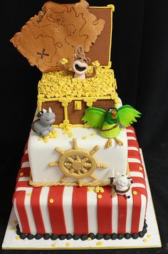 there is a cake made to look like a pirate's chest with animals on it