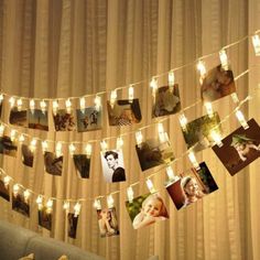 a string of lights that have pictures hanging from it's sides and are strung over a couch