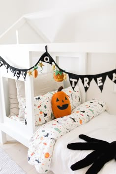 a white bed with halloween decorations on it