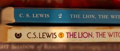 three books stacked on top of each other with the title c s lewis and the lion, the witch