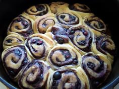 a pan filled with rolls sitting on top of a stove