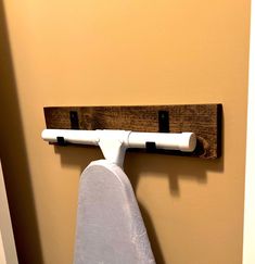 an ironing board mounted to the side of a wall