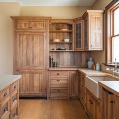 a kitchen with wooden cabinets and white counter tops