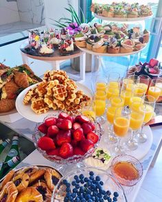 an assortment of desserts and pastries are on display at a buffet table in a restaurant