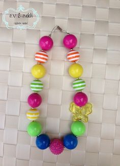 a colorful necklace is hanging on a wall