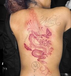 a woman with a dragon tattoo on her back