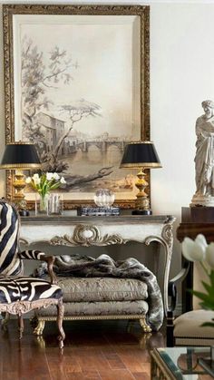 a living room filled with furniture and a zebra print chair in front of a painting