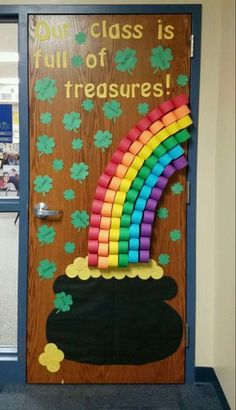 a classroom door decorated with rainbows and shamrock leaves