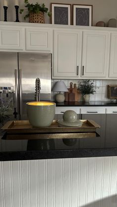 a bowl on a tray in the middle of a kitchen