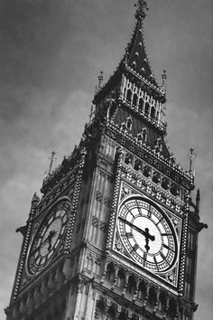 the big ben clock tower towering over the city of london, england in black and white