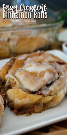 cinnamon rolls are sitting on a white plate