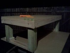 a table made out of pallets with a book on top and a pencil in the middle