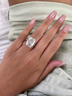 a woman's hand with a diamond ring on it