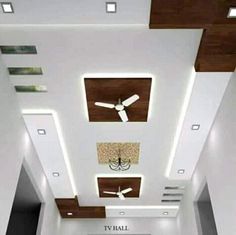 a living room filled with furniture and a ceiling mounted flat screen tv on the wall