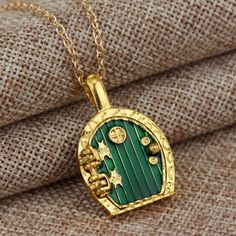 a necklace with a green door on it