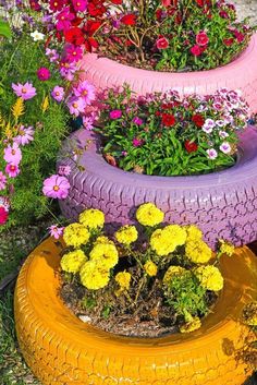 three tires stacked on top of each other with flowers in them