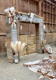 an outdoor area with hay and cow skulls