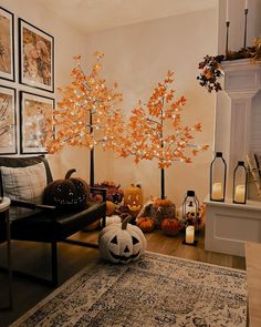 a living room decorated for halloween with pumpkins and trees