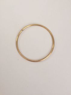 Let's get down to Brass...Stacks! Stack them high or wear one on its own, these bangles are sure to bring a touch of style to even the most casual of looks. Fabricated in jeweler's brass, these bangles are a great match (or substitute for) 14K yellow gold! These bangles are made in sturdy 10 gauge jeweler's brass wire and are measured by their interior diameters. Size Small - 2.25 inches (5.6cm). Size Medium - 2.5 inches (6.4 cm). Size Large - 2.75 inches (7 cm). If you are looking for a differe Minimalist Brass Bangle, Yellow Gold Hoop Bracelets, Classic Round Brass Bracelets, Adjustable Hoop Bangle For Everyday, Everyday Metal Bangle, Brass Bangle Bracelet For Everyday Wear, Vintage Brass Bracelet For Everyday Wear, Vintage Brass Bracelets For Everyday, Vintage Brass Bracelet For Everyday