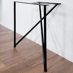 a black metal table sitting on top of a hard wood floor