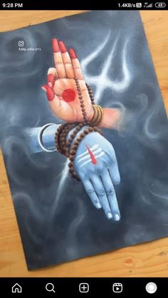 an image of a person's hand painted on a piece of paper with beads