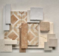 an abstract art work with different shapes and sizes on the wall, including tiles in various colors